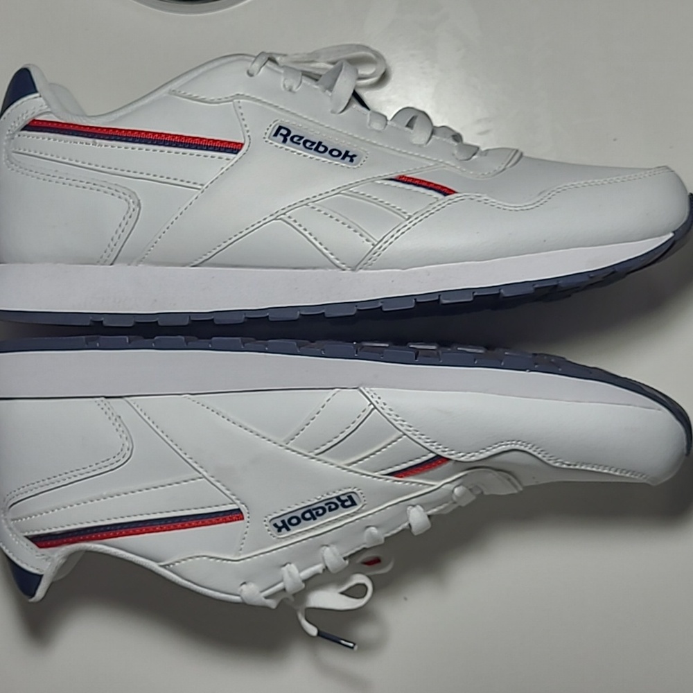 Reebok man's white/blue & red stripe.Size12 1/2 no tags a small Spot on the Sigh